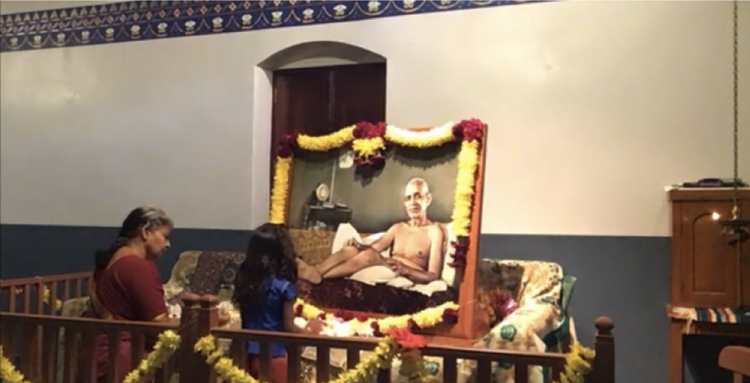 Flowers being offered at the feet of Sri Bhagavan at the New Old Hall in Tampa, Florida.