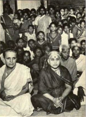 Attending Darshan, Sri Ramana's disciples site crosslegged and silent, listening to his comments on life and Hindu theology.