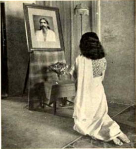 Rival holy man, Sri Aurobindu's ashrama is in neighvoring Pondicherry. A woman dressed in a sari kneels in prayer before a photograph of the master.